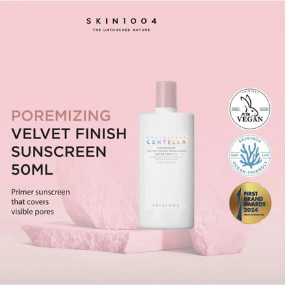 SKIN1004 poremizing velvet finish sunscreen bottle on a pink background with branding and certification logos.